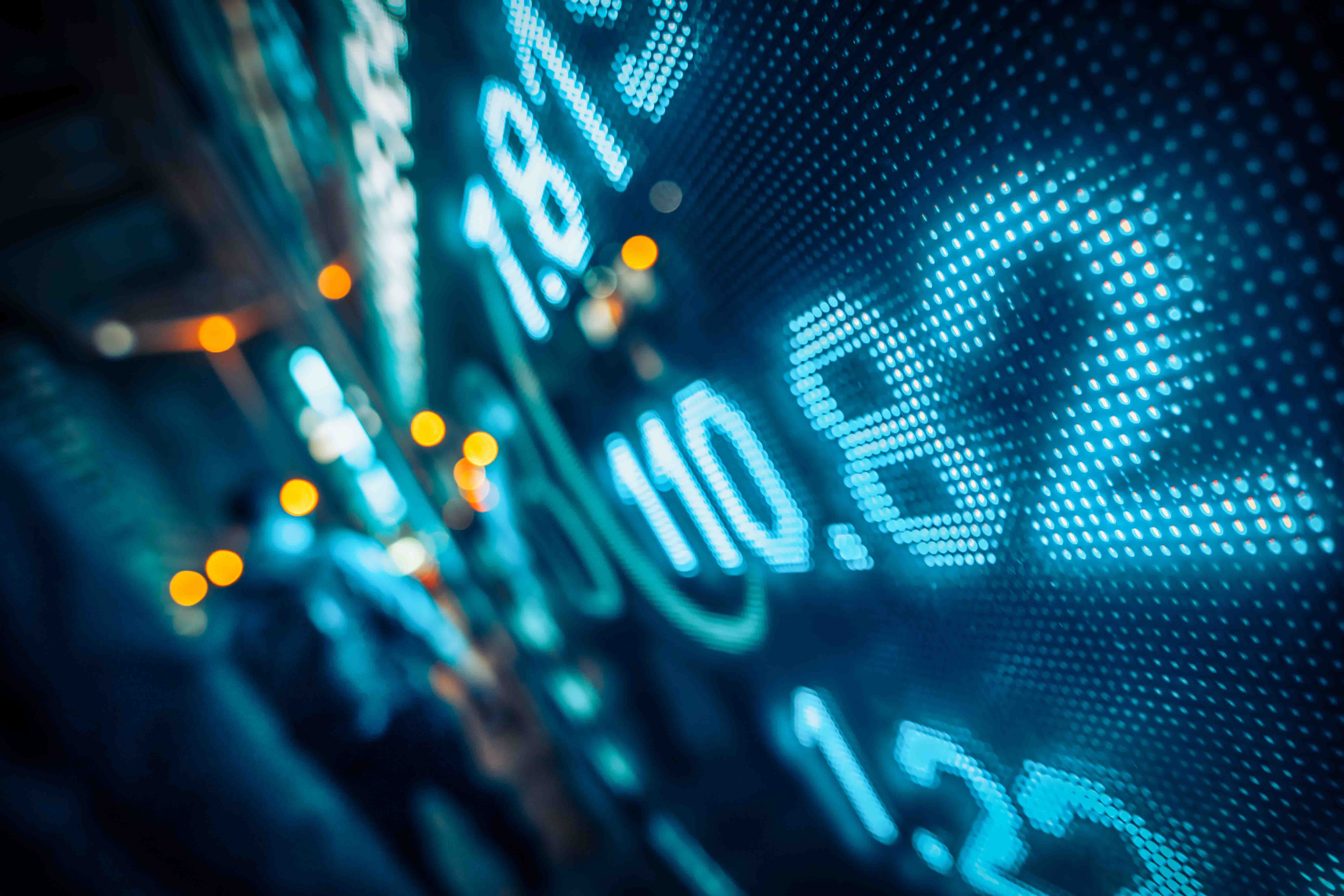 Computer screen showing stock market graphics and values.